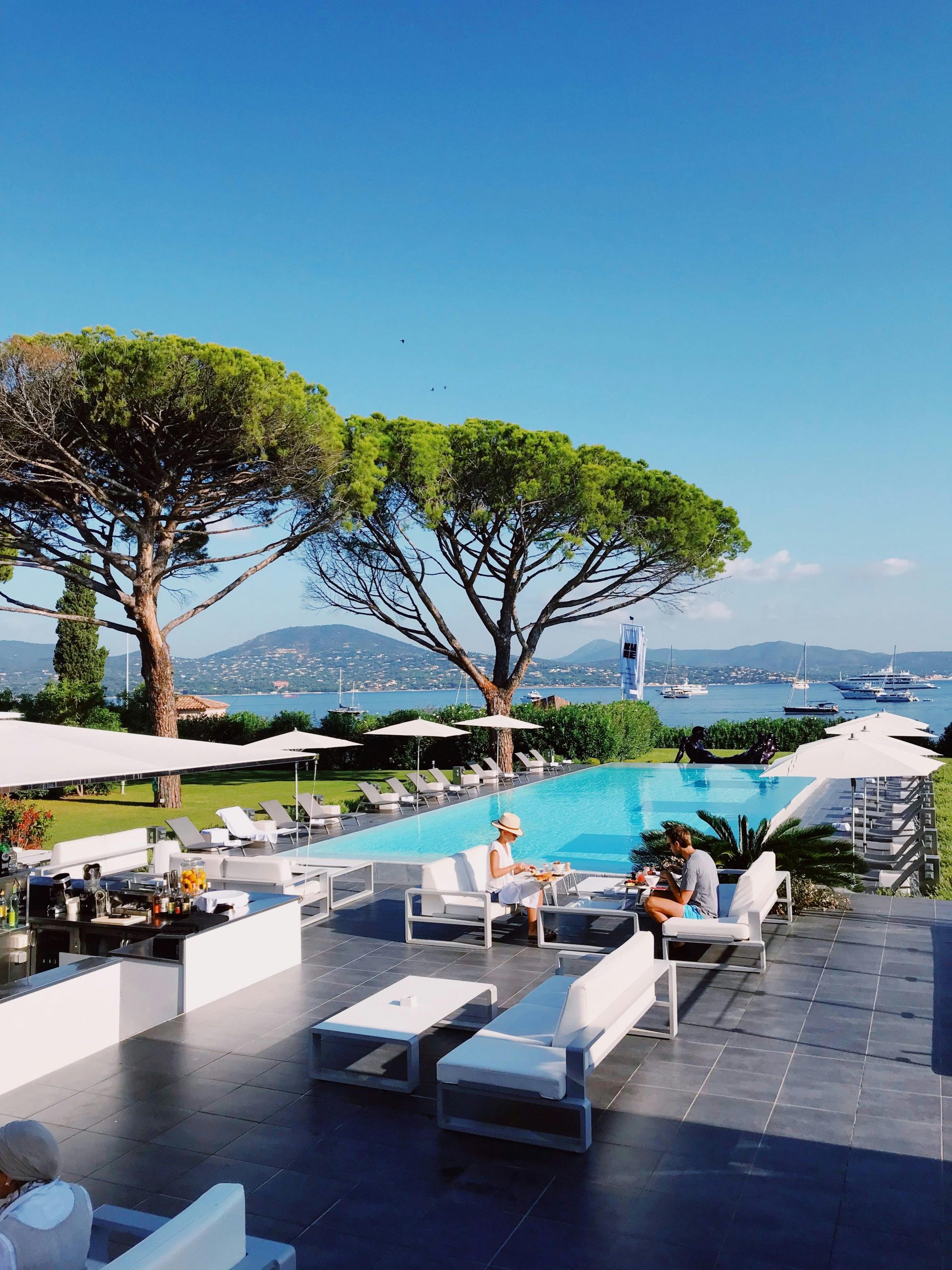 Relax by the infinity pool at a Saint-Tropez resort with stunning Mediterranean views.